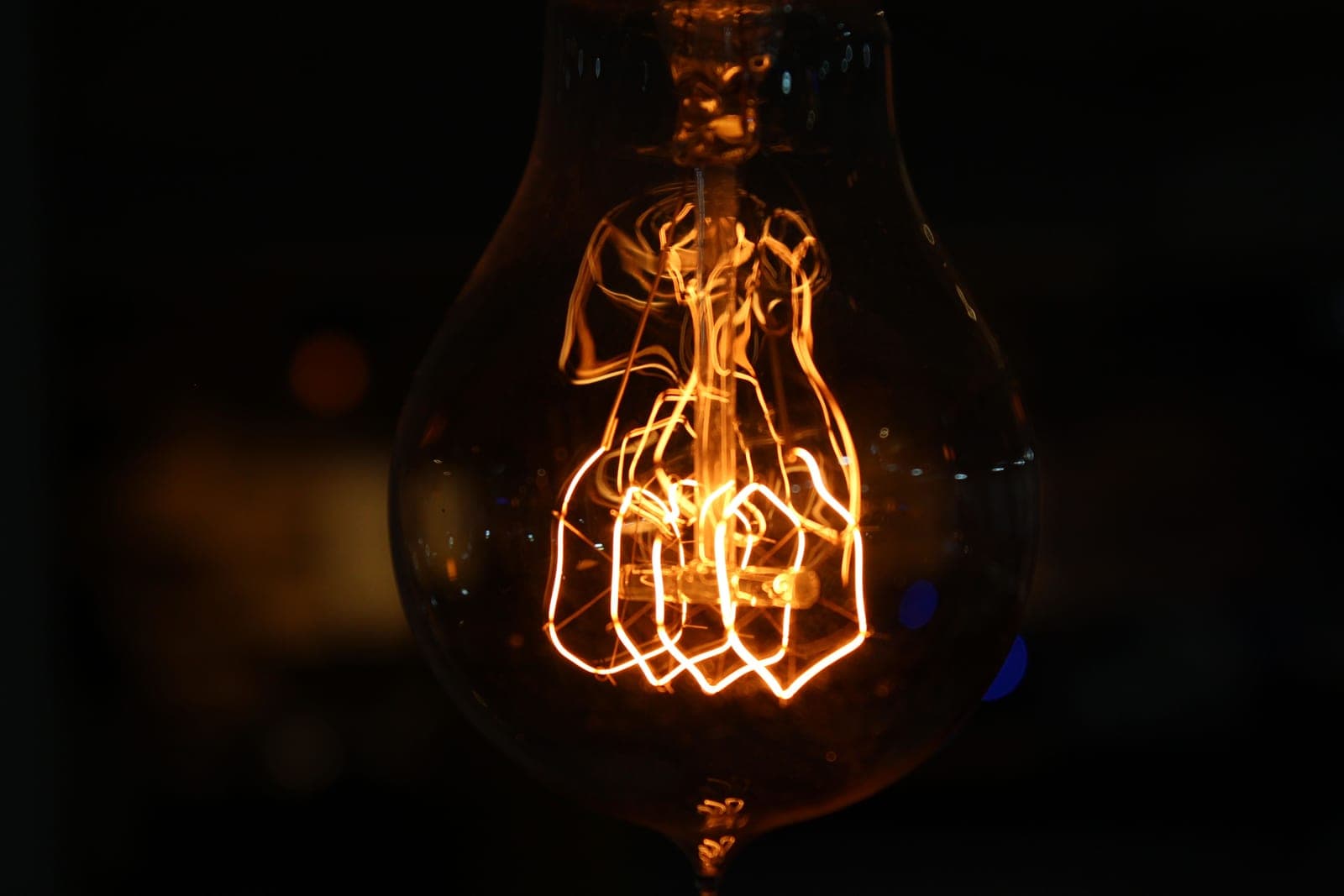 A red infrared heat lamp bulb glowing in a fixture